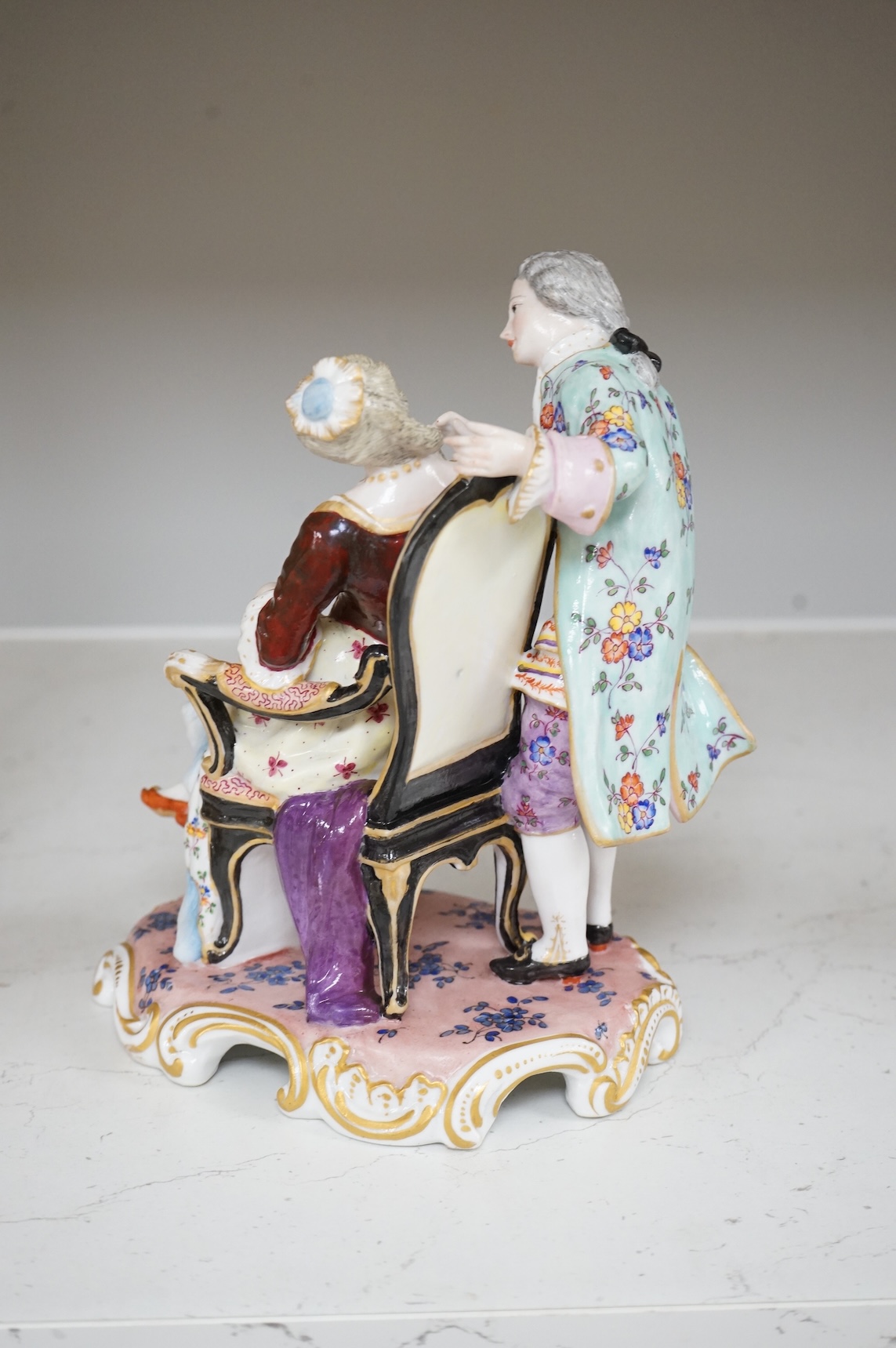 A German porcelain group of a seated sleeping beauty, 21cm high